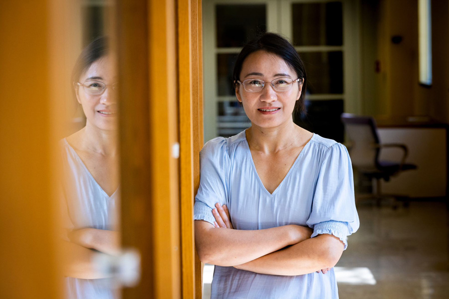 Aihua Li is standing in the office | Master's in Data Science