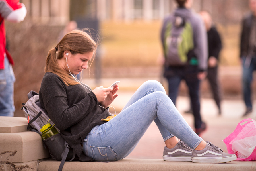 student seated outside