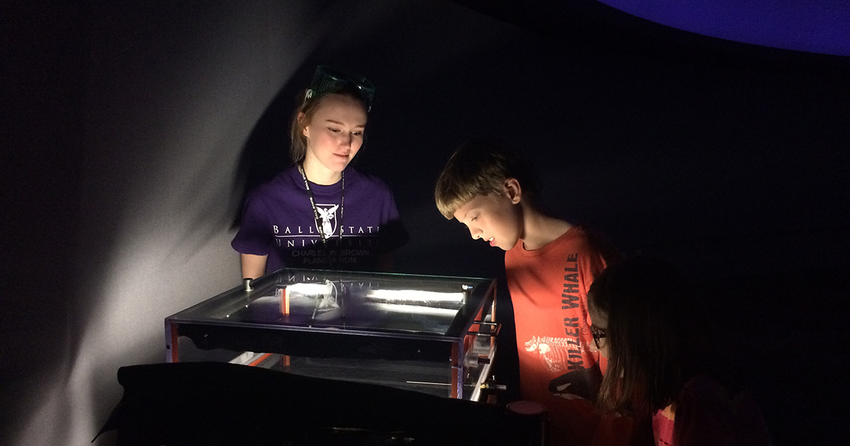 student working in planetarium