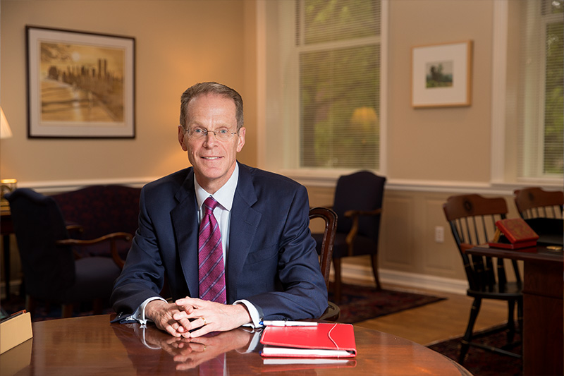President Mearns behind desk