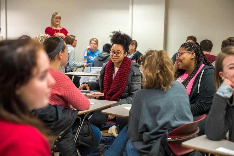 students talking in a classroom