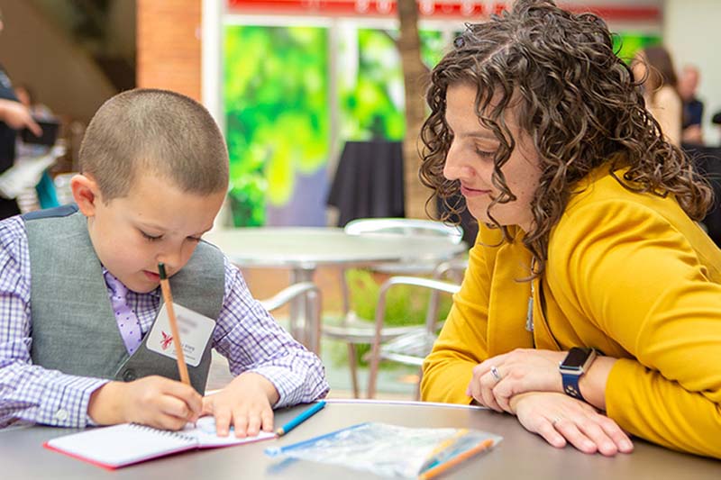 Student helping child