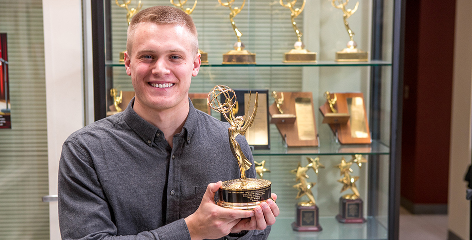 Student holding Emmy Award