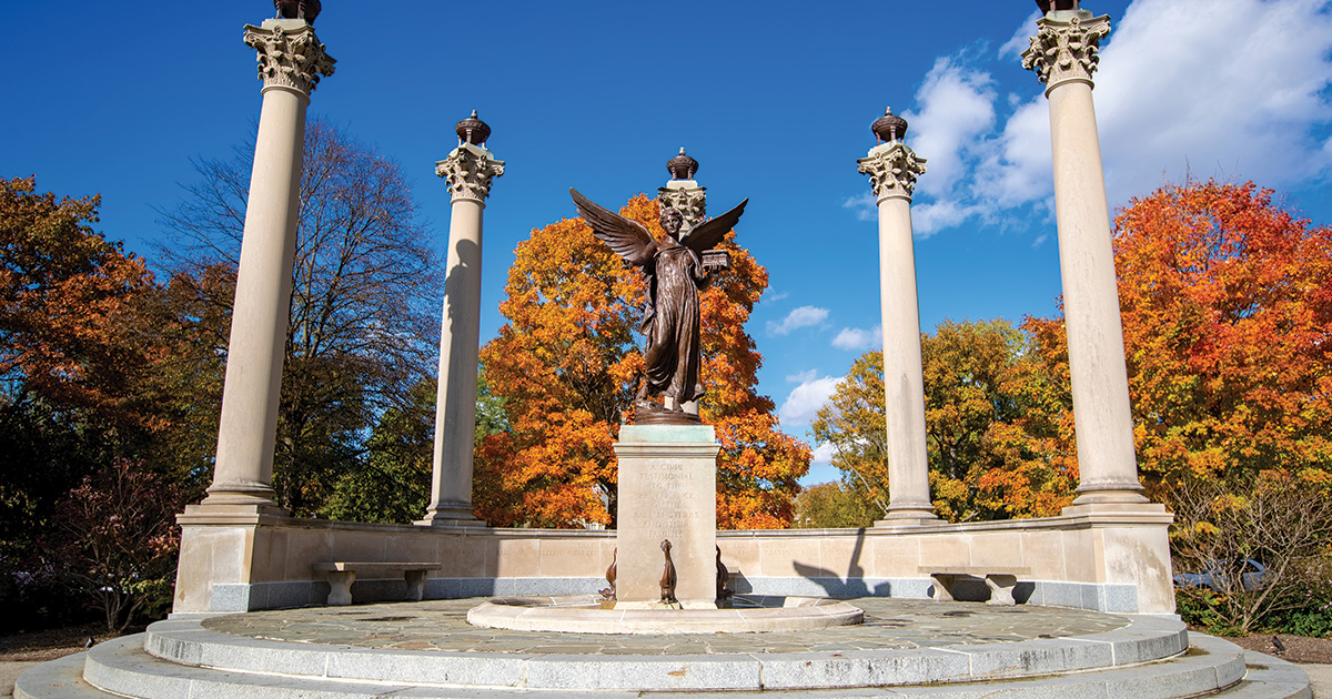 Beneficence Statue Fall leaves and blue sky