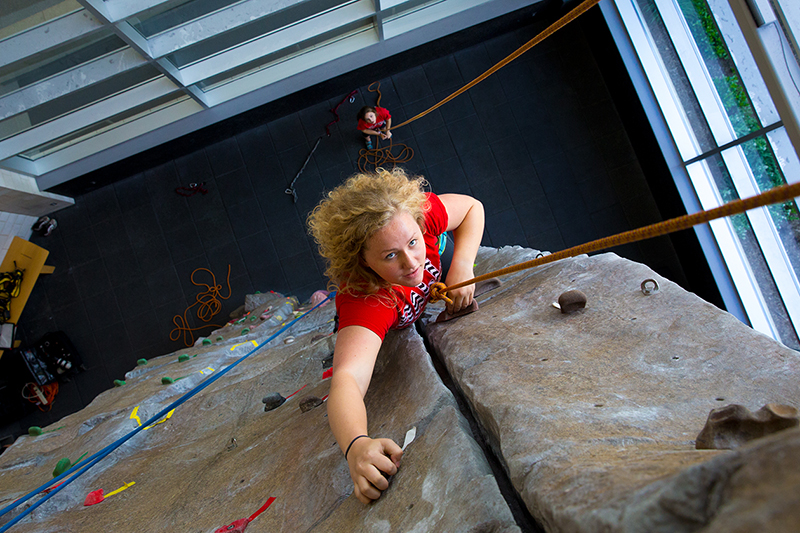 Student on a rock climbing wall