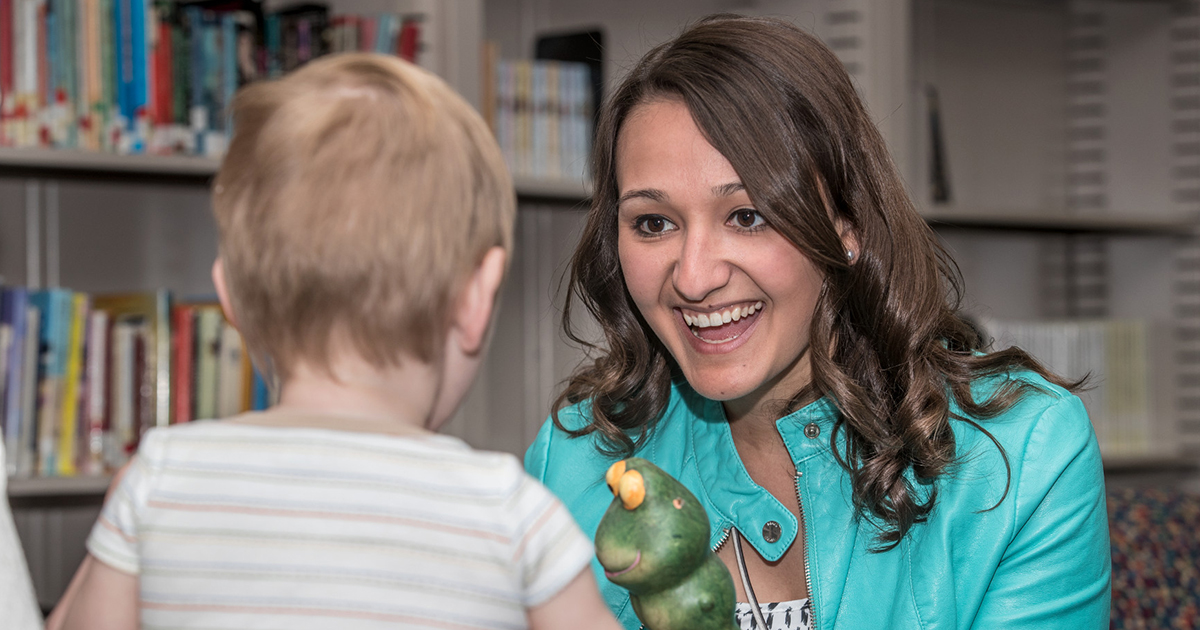 A Ball State student works with a child.