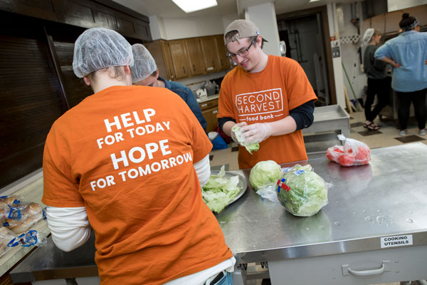 students preparing food in the Second Harvest Food Bank kitchen