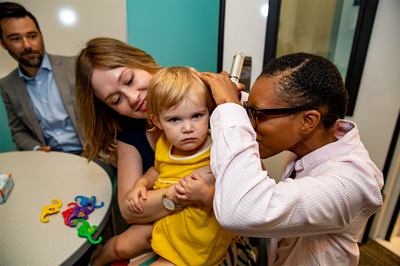 An Audiology student checks the hearing on a patient