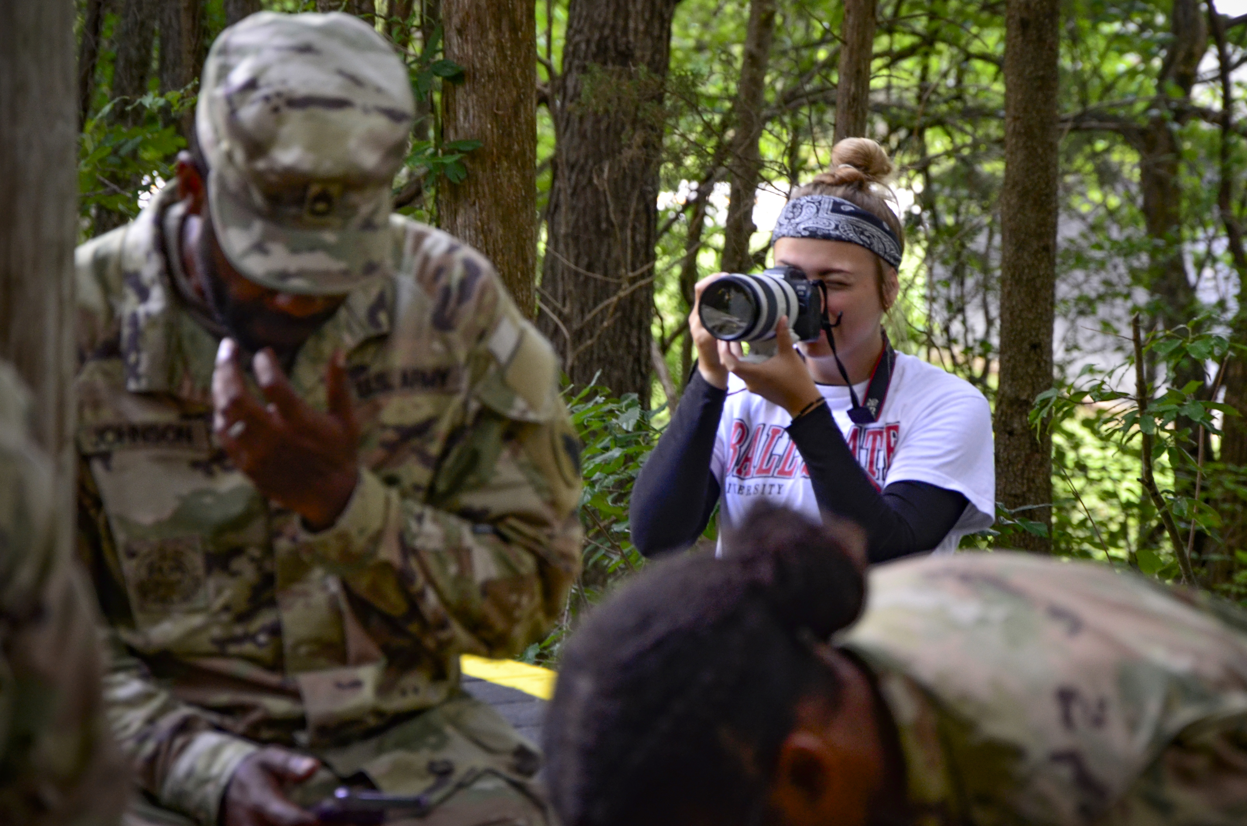 A woman takes photos of soldiers training at Fort Bragg