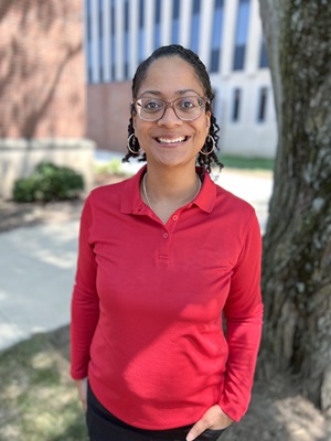 Headshot of a woman standing in front of the Teachers College building on the Ball State University campus.