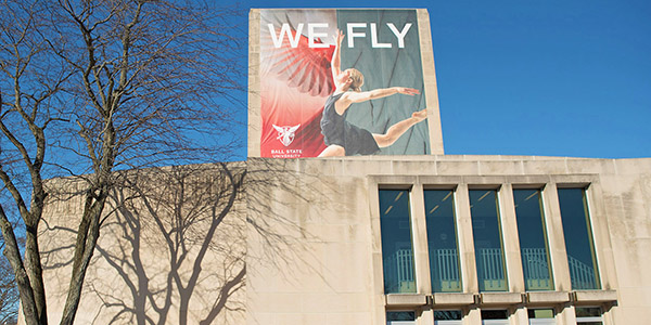 Teachers College Building with 'We Fly' banner