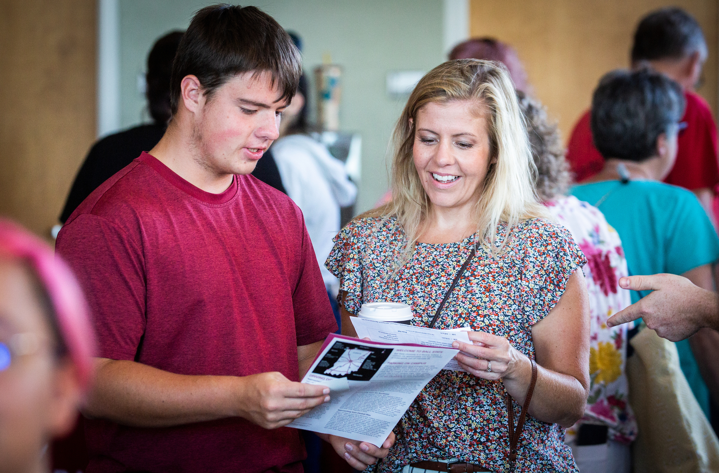 Attendees of Experience BSU Day looking at their agenda in Pruis Hall