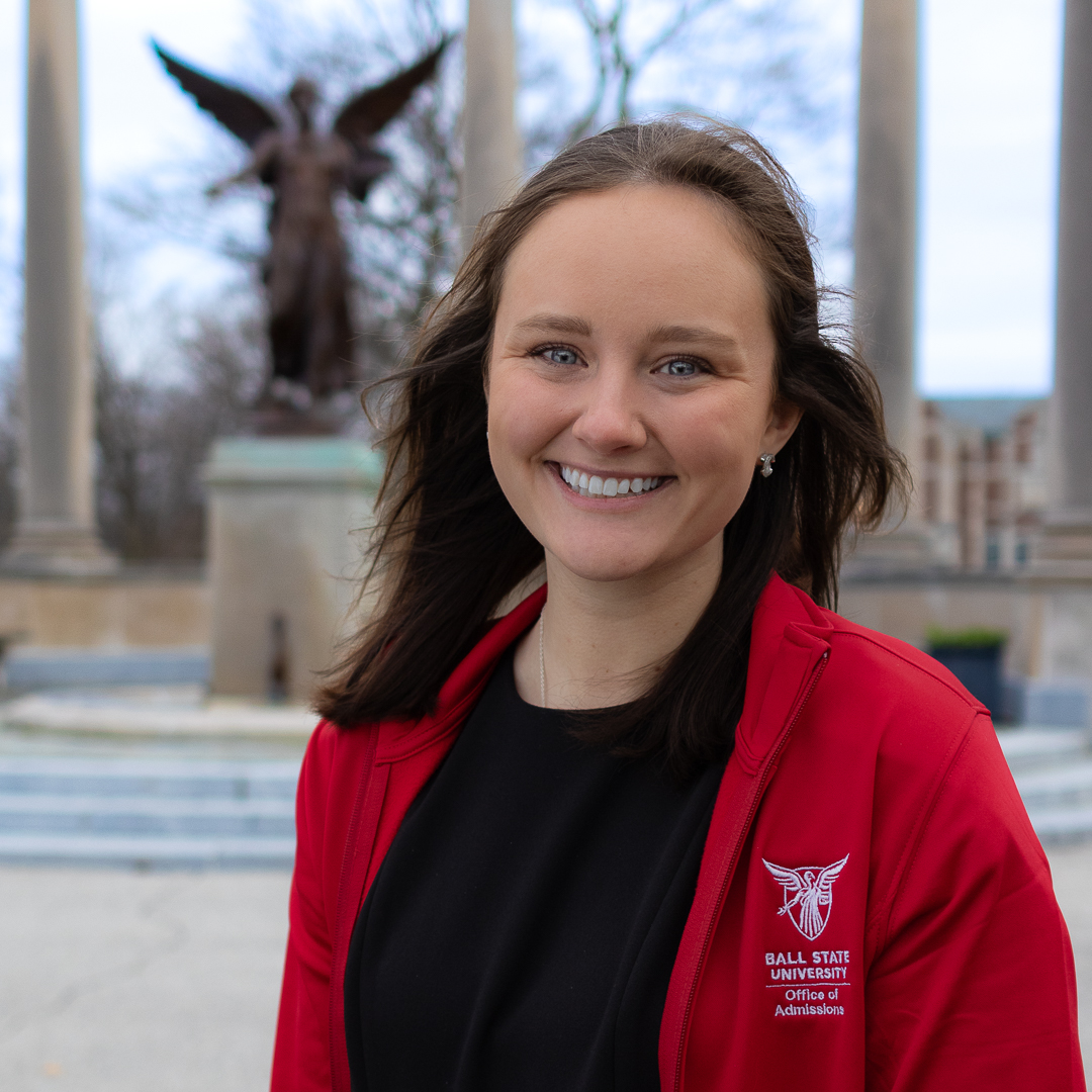 Professional headshot of Kate Bowling with Beneficence Statue blurred in the background.
