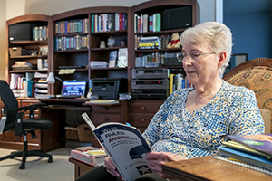 Online BGS student Jane Miller reading a book