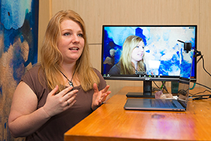 Online BGS student Sophia Benedict speaking while seated at a desk in Indiana