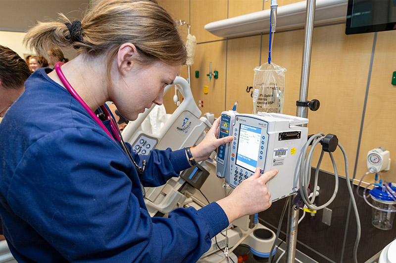 Students work with a professor in the Cardinal Simulation Lab