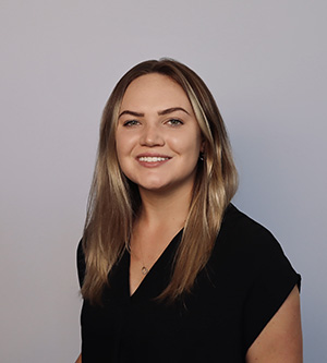 Haley Young smiles for a professional portrait against a light gray background.