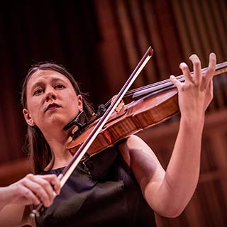 A violist performing on stage