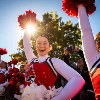 a Ball State cheerleader outside cheering at CharlieTown