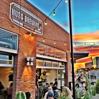 Outside of Huss Brewing with sunset in backgroudn