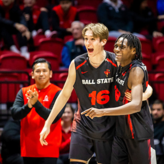 Two members of the Ball State Mens Volleyball team on the court celebrating