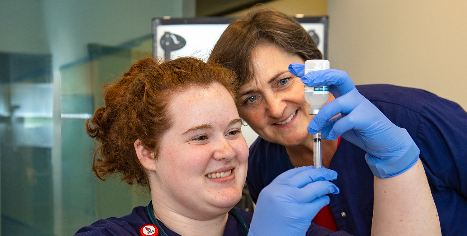 Faculty member works with a student