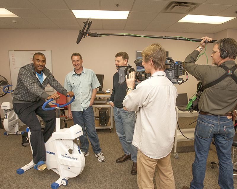 World class sprinter Colin Jackson (left) prepares for the filming of a British Broadcasting Company (BBC) documentary with Scott Trappe, HPL director.