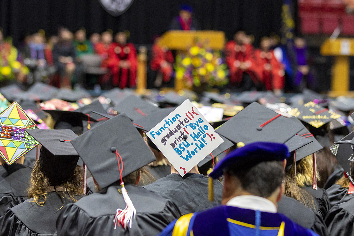 Decorated graduation cap that reads 'Function graduate (){print('Bye BSU, Hello World')}