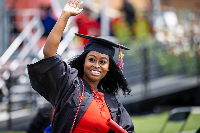Graduate waving