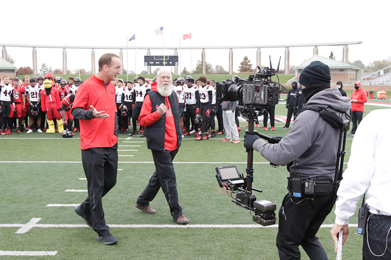 David Letterman and Payton Manning on the football field