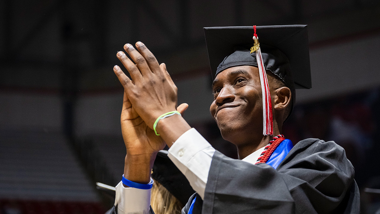 Student clapping and smiling