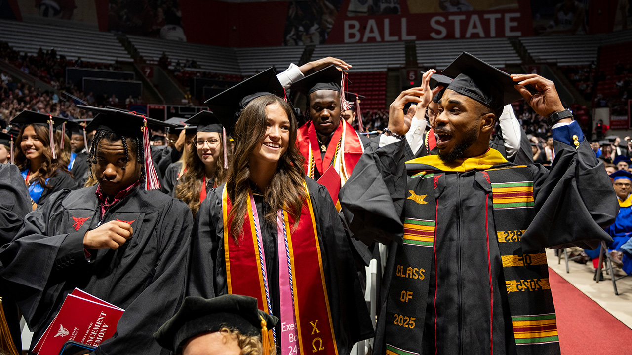Students with hands raised celebrating