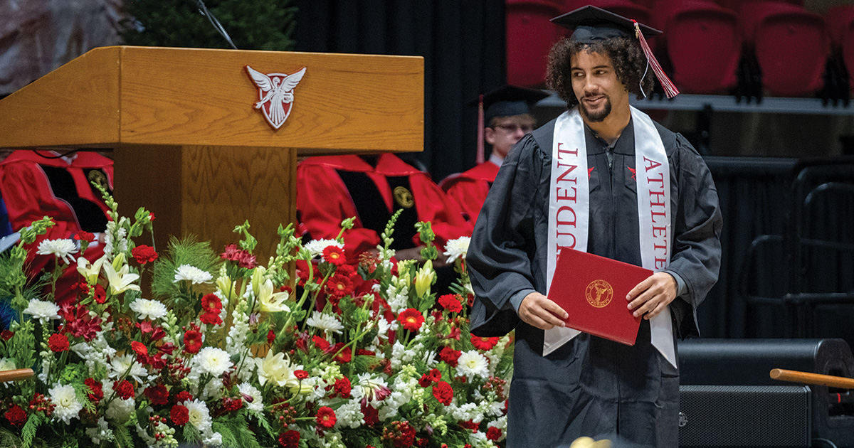 Student athlete receiving diploma