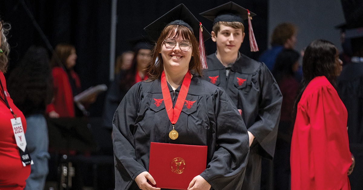 Student smiling after receiving diploma