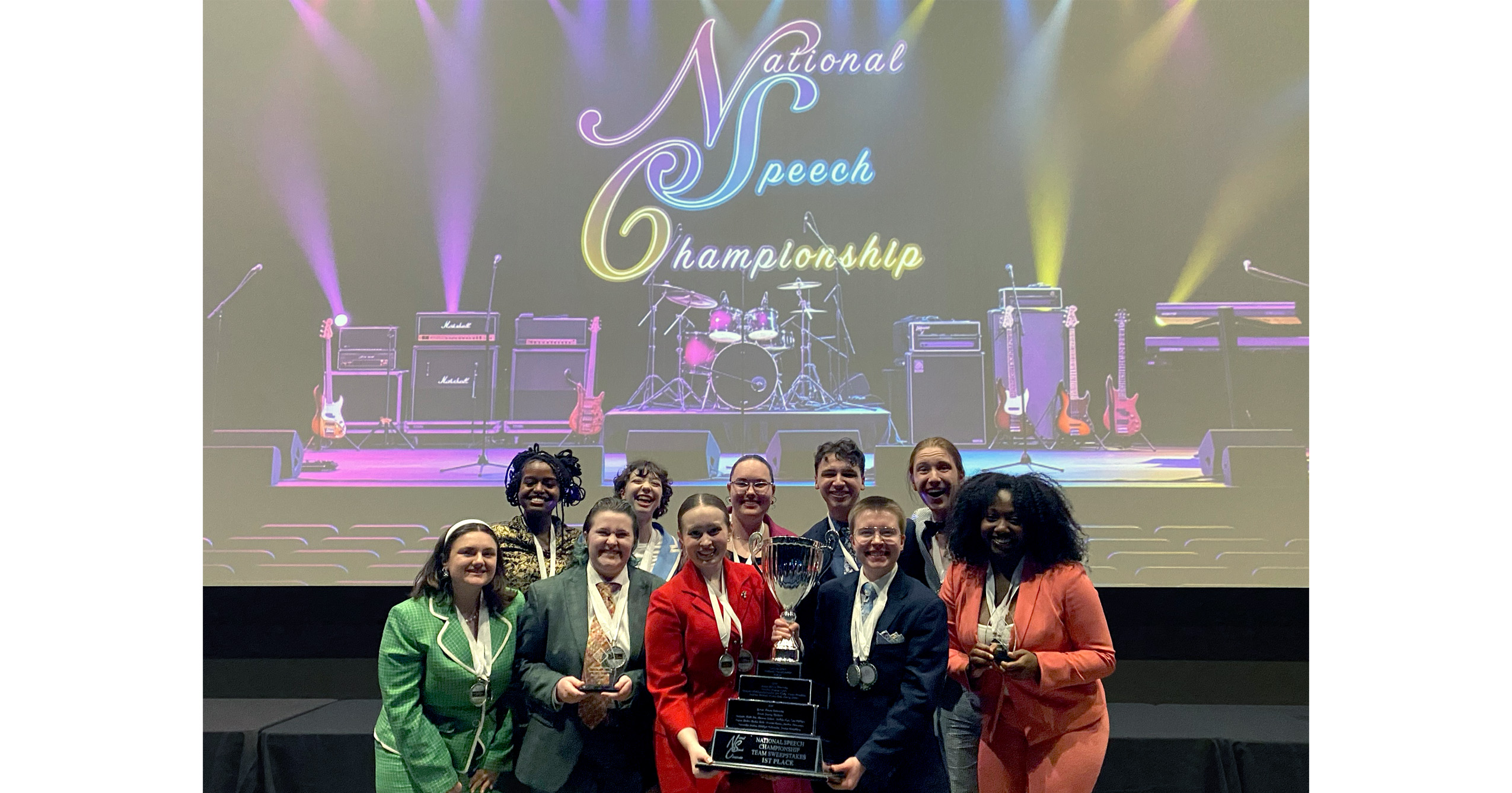Ball State University Speech Team members pose with medals and trophies after winning the 2026 National Speech Championship.