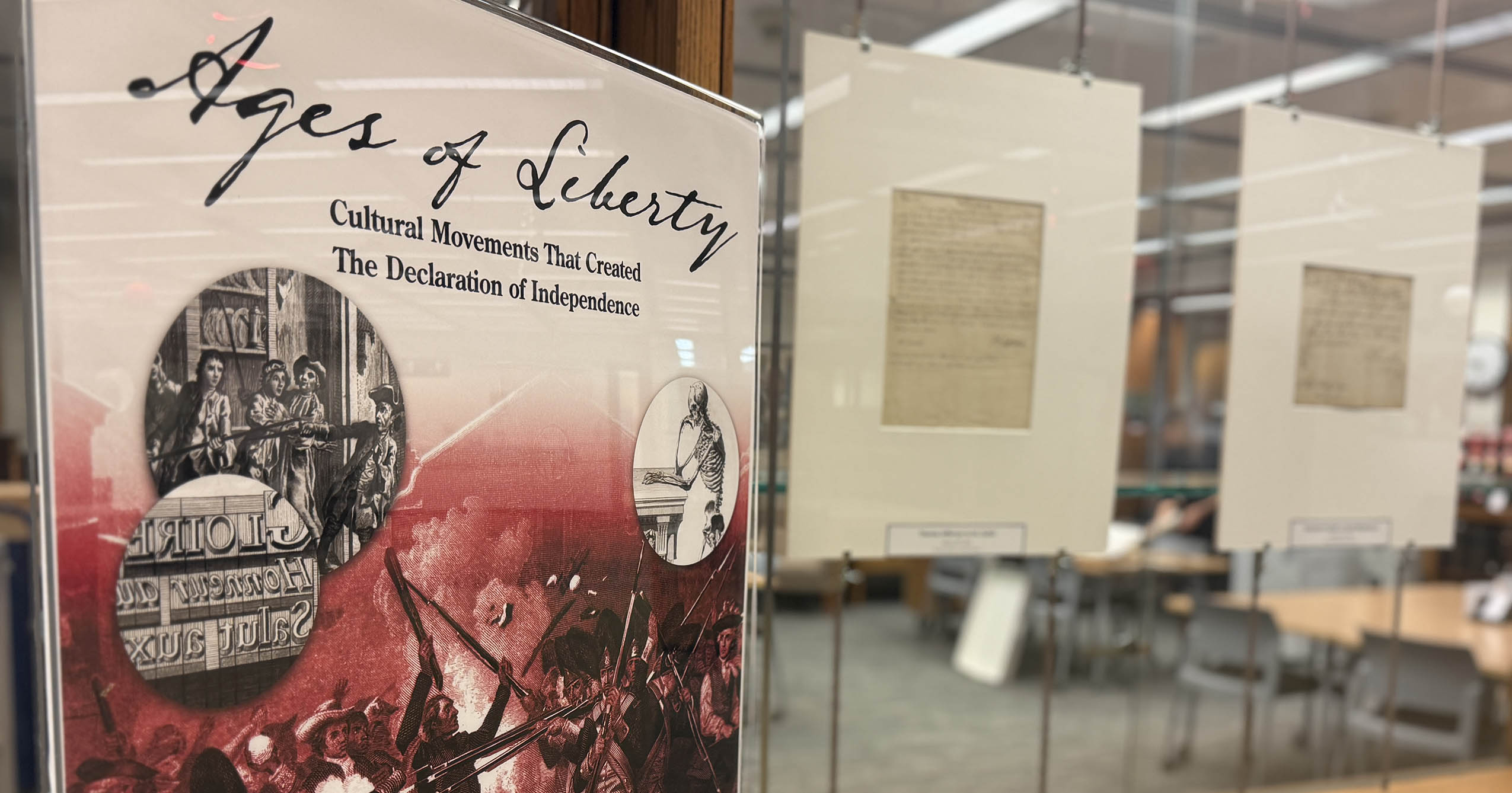 Ages of Liberty exhibit signage and historical documents displayed in glass cases at Ball State University’s Bracken Library.