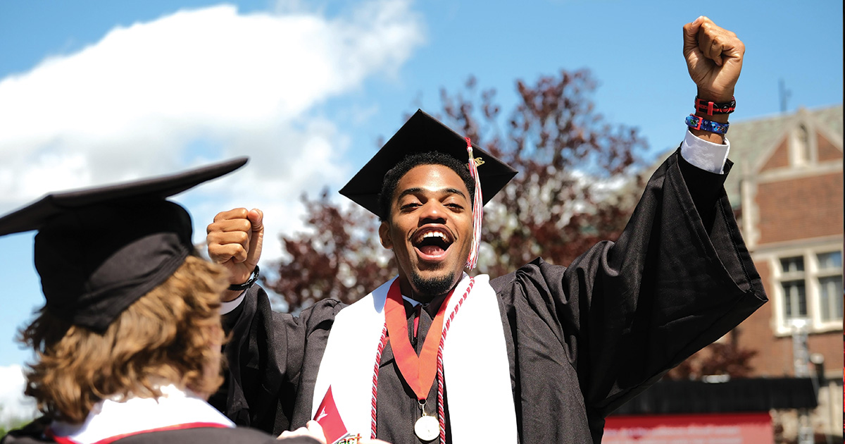 Graduate celebrates with fist raised in the air