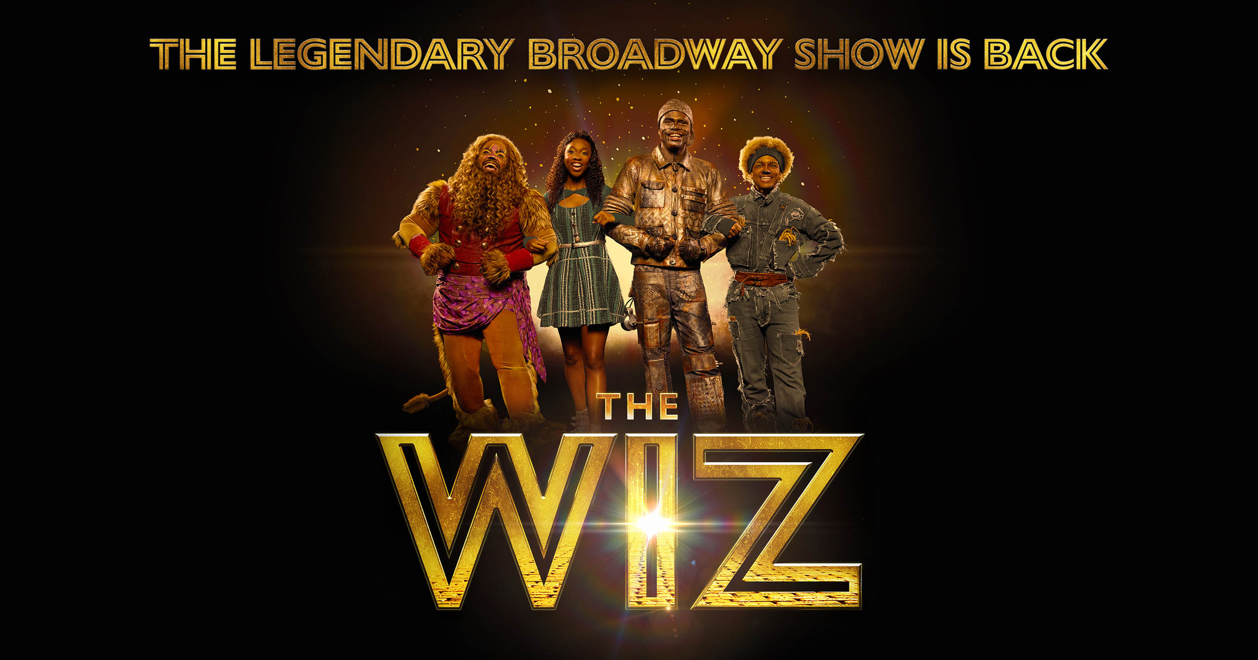 Promotional artwork for The Wiz featuring Dorothy, the Tinman, the Scarecrow, and the Cowardly Lion above the musical’s gold logo.