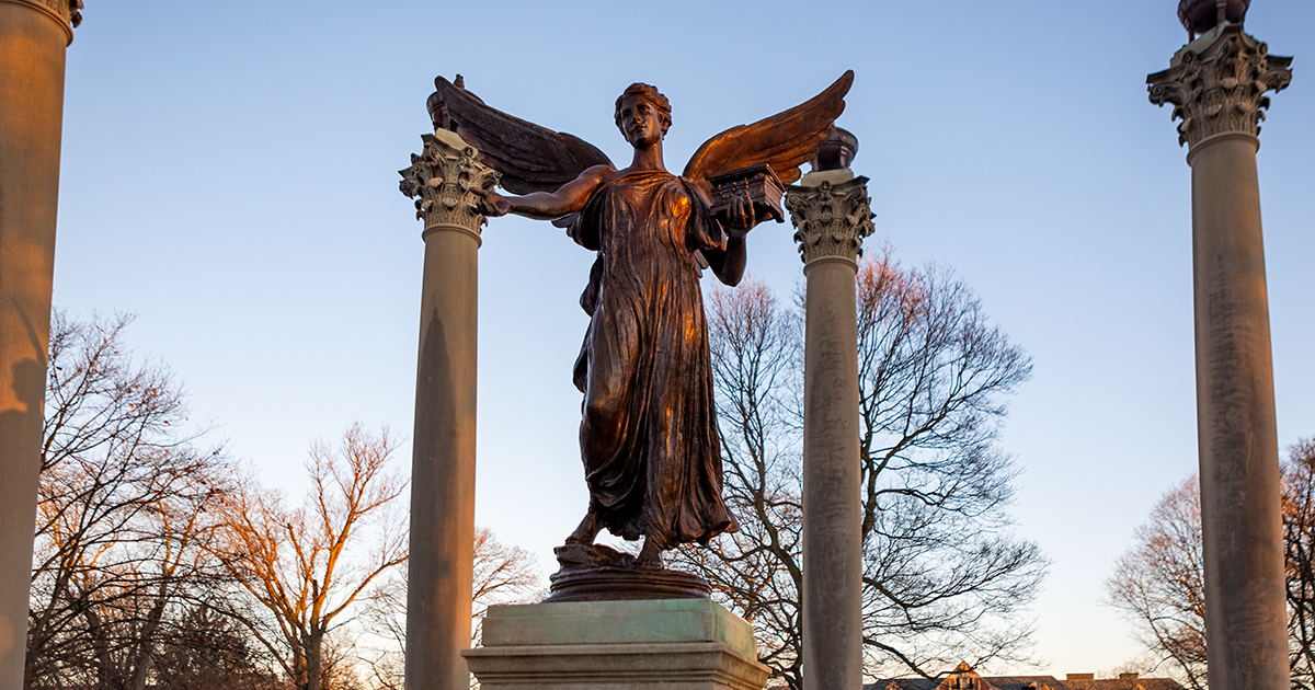 Ball State University Beneficence Statue with a sunset in the background